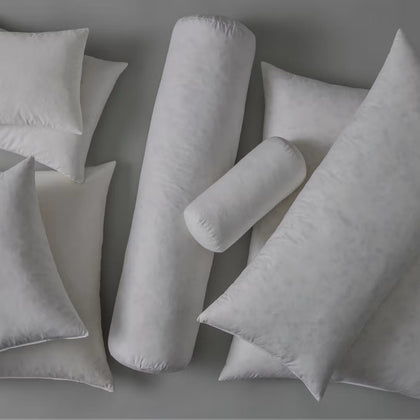 Assortment of pillow and bolster inserts in various shapes and sizes.
