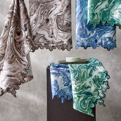 Balthazar marbled napkins in brown, blue and green draped near a soap bar.