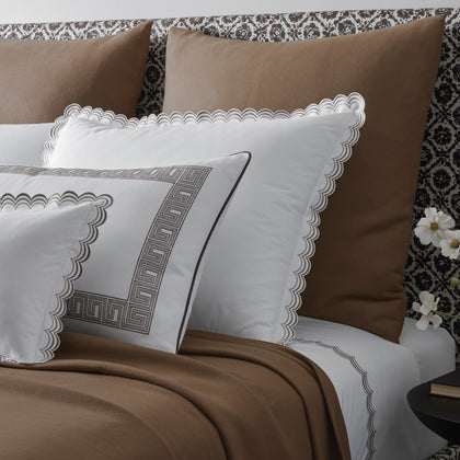 Dream Modal brown throw blanket styled on a bed with scalloped white shams