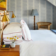 Ansonia white bedding with red border trim styled on a bed