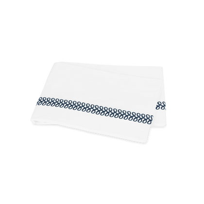 Deep blue Astor Braid flat sheet, folded.