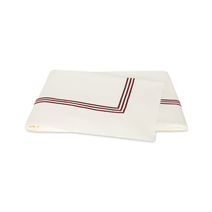 Ivory and red Bel Tempo Nocturne flat sheet, folded.