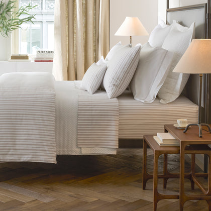 Bedroom view of Calypso tan striped bedding styled on a bed.
