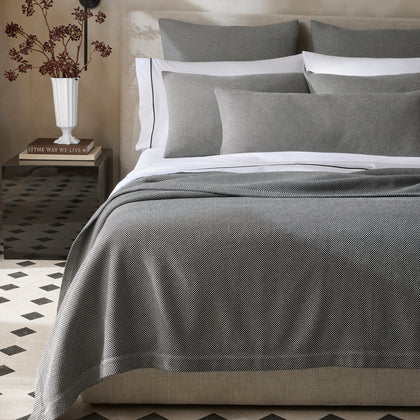 Bed dressed in a black-and-white Jackson check coverlet and shams.