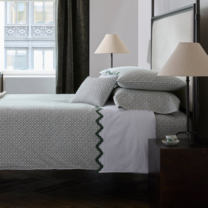 Laksha moss floral-print bedding styled on a bed by a window
