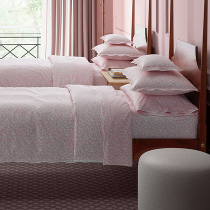 Pink Margot vine-print bedding styled on twin beds in a pink bedroom.