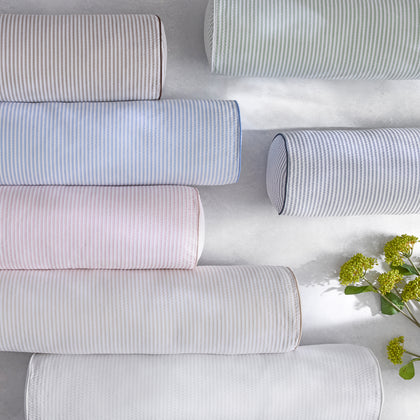 Matteo striped round bolster pillows in pastel colors with flowers