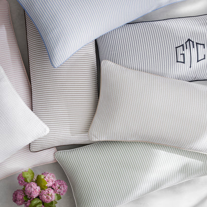 Matteo striped lumbar pillows styled on a bed
