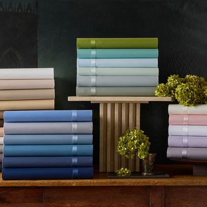 Nocturne sateen sheet stacks in cream, blue, green, and pastel colorways