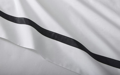 Black ribbon on white fabric