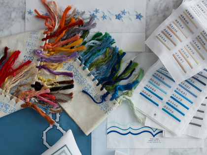 Embroidery thread swatches laid out for a design concierge consultation