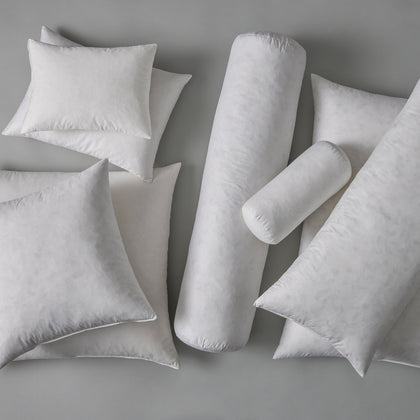 White down pillow and bolster inserts in assorted shapes and sizes.