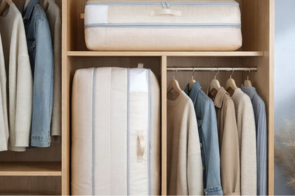 Zippered canvas storage bags holding folded bedding on a closet shelf.