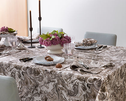 Table set with Matouk Schumacher Balthazar marbled-print linens and fresh flowers