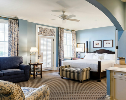 Ocean House in Watch Hill, RI: coastal guest room with four-poster bed, soft blue walls and blue floral drapes