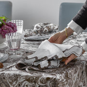 Place setting with Balthazar marbled linens and Aziza scalloped napkins.
