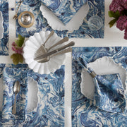 Balthazar blue marbleized placemats and napkins set with scalloped plates