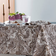 Balthazar marbleized tablecloth styled with candles and a flower centerpiece