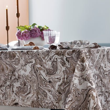 Balthazar marbleized tablecloth styled with candles and a flower centerpiece
