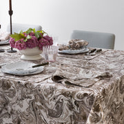 Balthazar marbleized tablecloth styled on a dining table with flowers