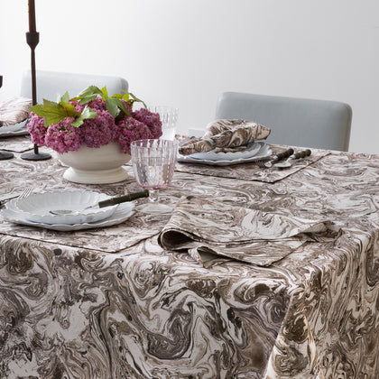 Balthazar marbleized tablecloth styled on a dining table with flowers