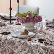 Balthazar marbleized tablecloth styled with florals and a plate of macarons
