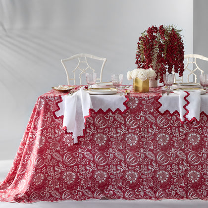 Red Granada floral print tablecloth set for a holiday table with a berry centerpiece.