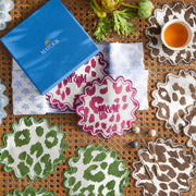 Monogrammed Iconic Leopard cocktail napkins in crimson, green, and brown