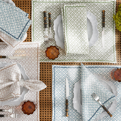 Schumacher Matouk Laksha table linens in green, blue, and brown block print