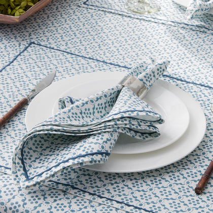 Blue and white Schumacher Matouk Laksha napkin at a place setting