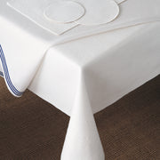 Felt table silencer pad layered under a white tablecloth with blue trim
