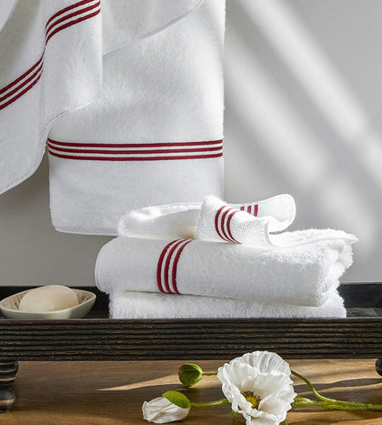 White Bel Tempo towels with a red stripe border, stacked.