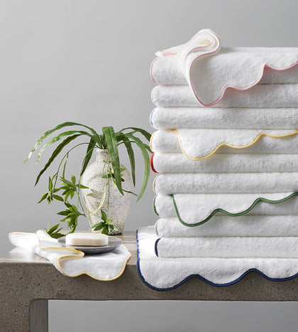 White Cairo Scallop towels with colorful scalloped edges, stacked.