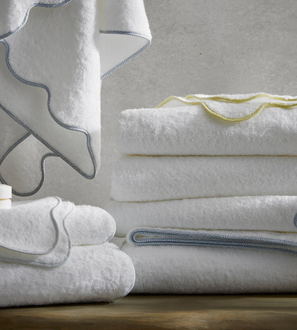 White Jasper towels with a scalloped trim, stacked.