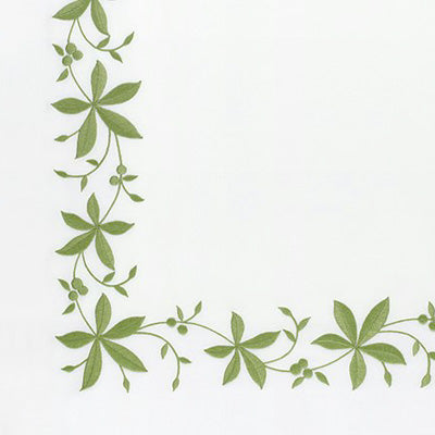 Close up of a napkin with green vine and leaf corner border design