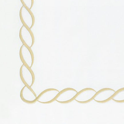 Close up of a napkin with twisted rope corner detail in a light natural beige color
