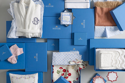 Assorted Matouk gift boxes with a robe, towels and accessories.
