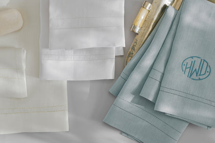 White, cream and blue guest towels, one monogrammed.