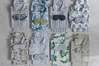 Pajama sets and sleep masks in assorted prints, folded.