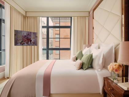 Neatly made bed with decorative pillows in a stylish bedroom.