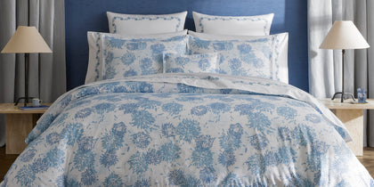 Chrysanthemum floral print styled in a blue bedroom vignette.