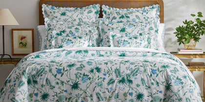 Palmyra tropical print styled in a green bedroom vignette.