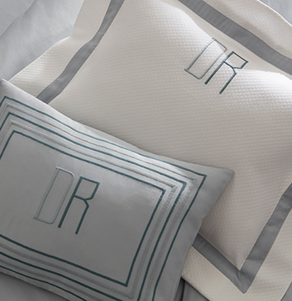 Monogrammed white and gray pillow shams with a block-letter monogram
