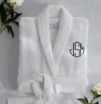 Folded white monogrammed robe with flowers