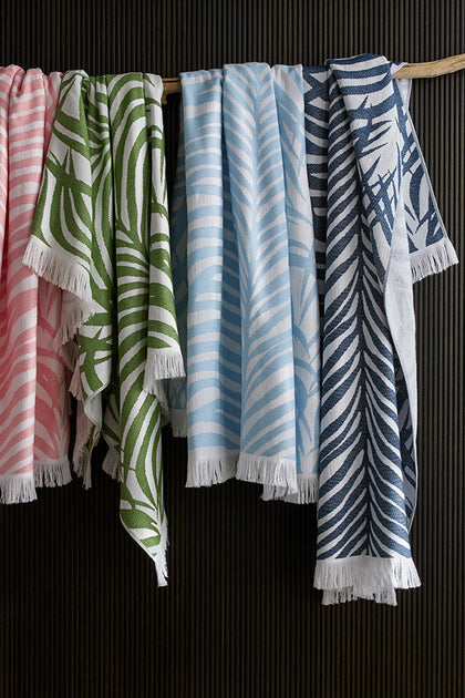 Schumacher beach towels with fringe, hanging.