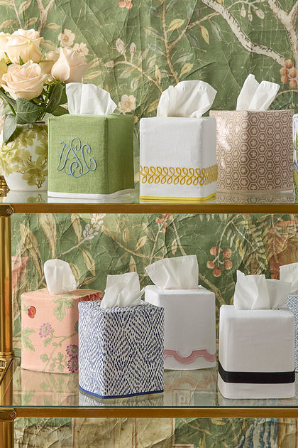 Schumacher tissue box covers in assorted prints, displayed on shelves.