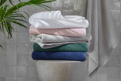 Athena waffle-weave towels in assorted colors, stacked.