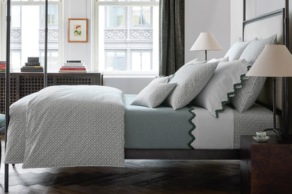 Laksha moss floral-print bedding styled on an iron bed frame