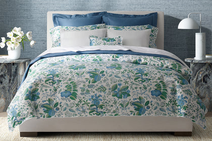 Pomegranate floral bedding styled on a bed.
