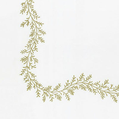 Close up of a napkin featuring a delicate olive green leafy garland border along the top and left edges.